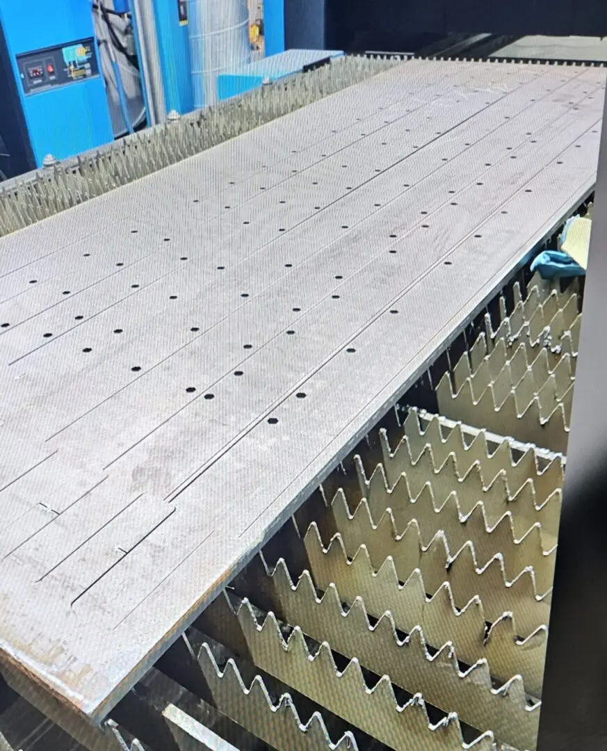 A large white machine with many rows of nails.