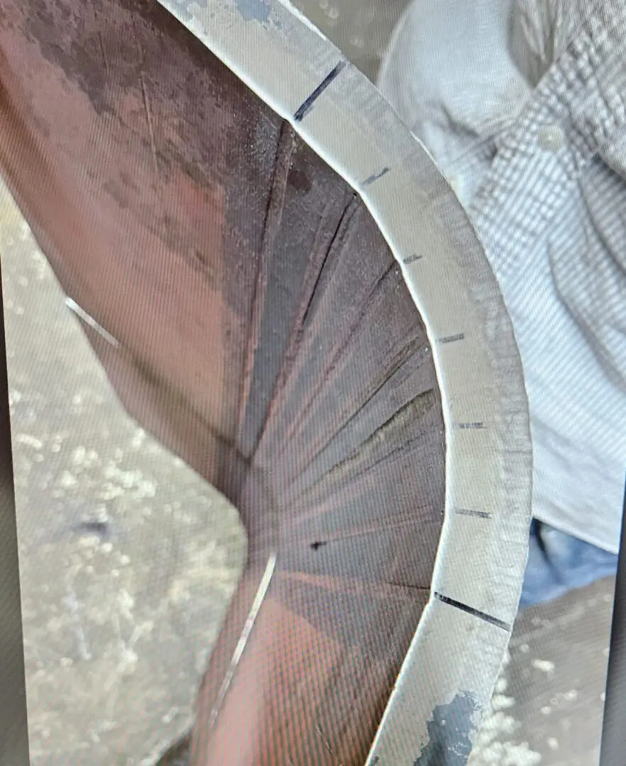 A close up of the bottom of a wooden wheel.