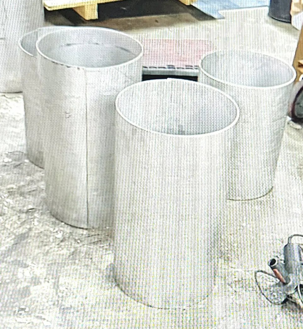 Three white cylinders sitting on a floor.