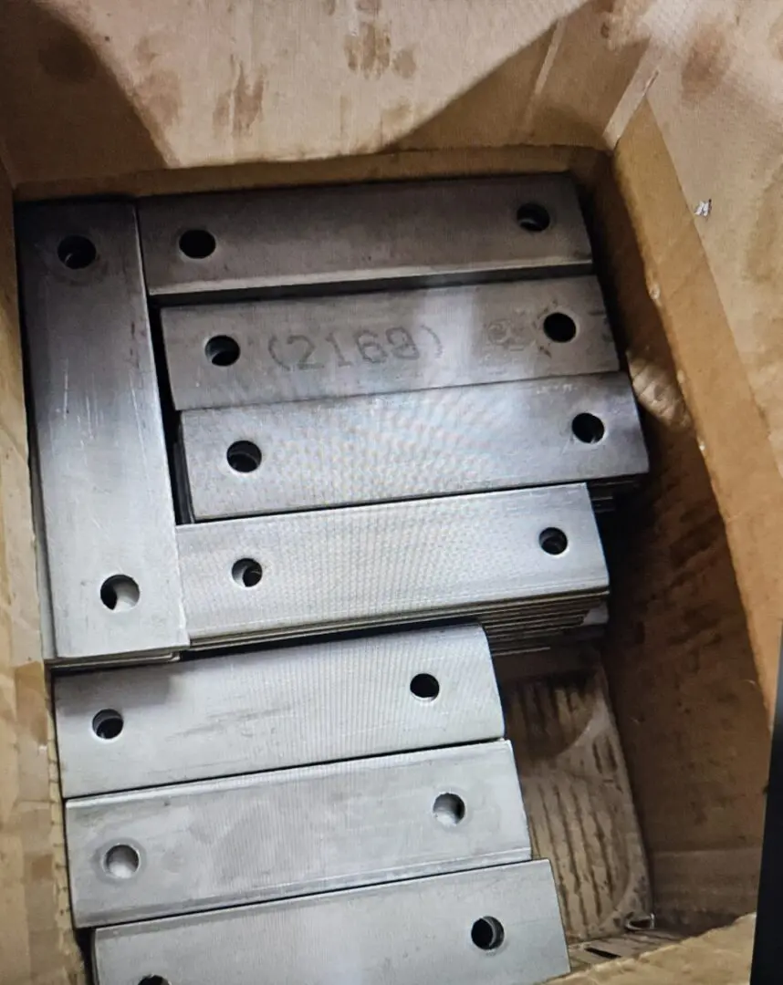 A group of metal plates sitting on top of cardboard.