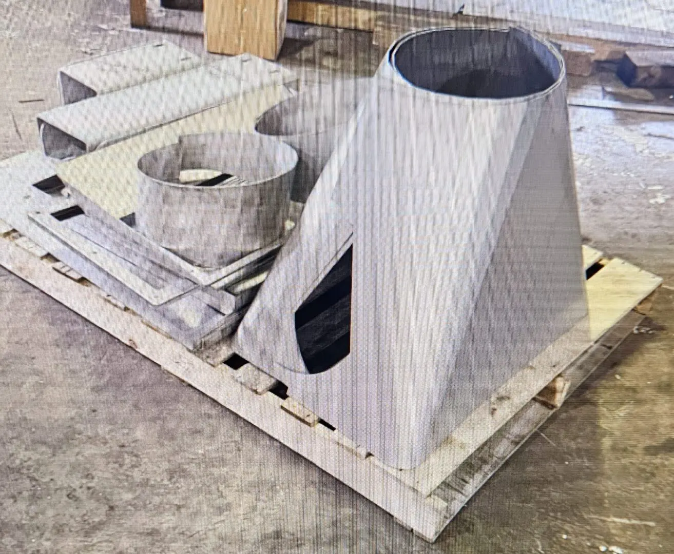 A white object sitting on top of a wooden pallet.