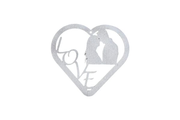 A heart shaped metal sign with the word love and a picture of two people kissing.