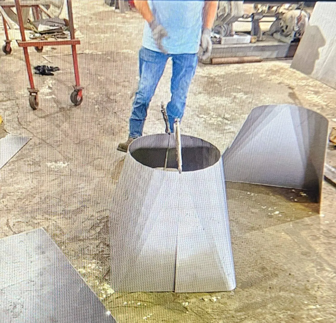 A man is using an iron hammer to make concrete.