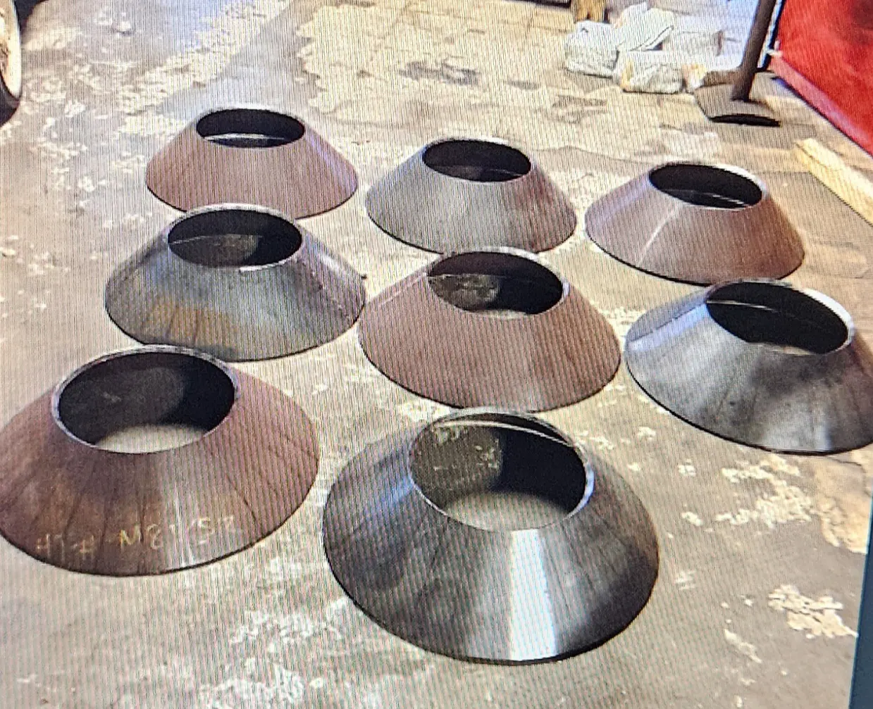 A group of metal bowls sitting on top of a floor.