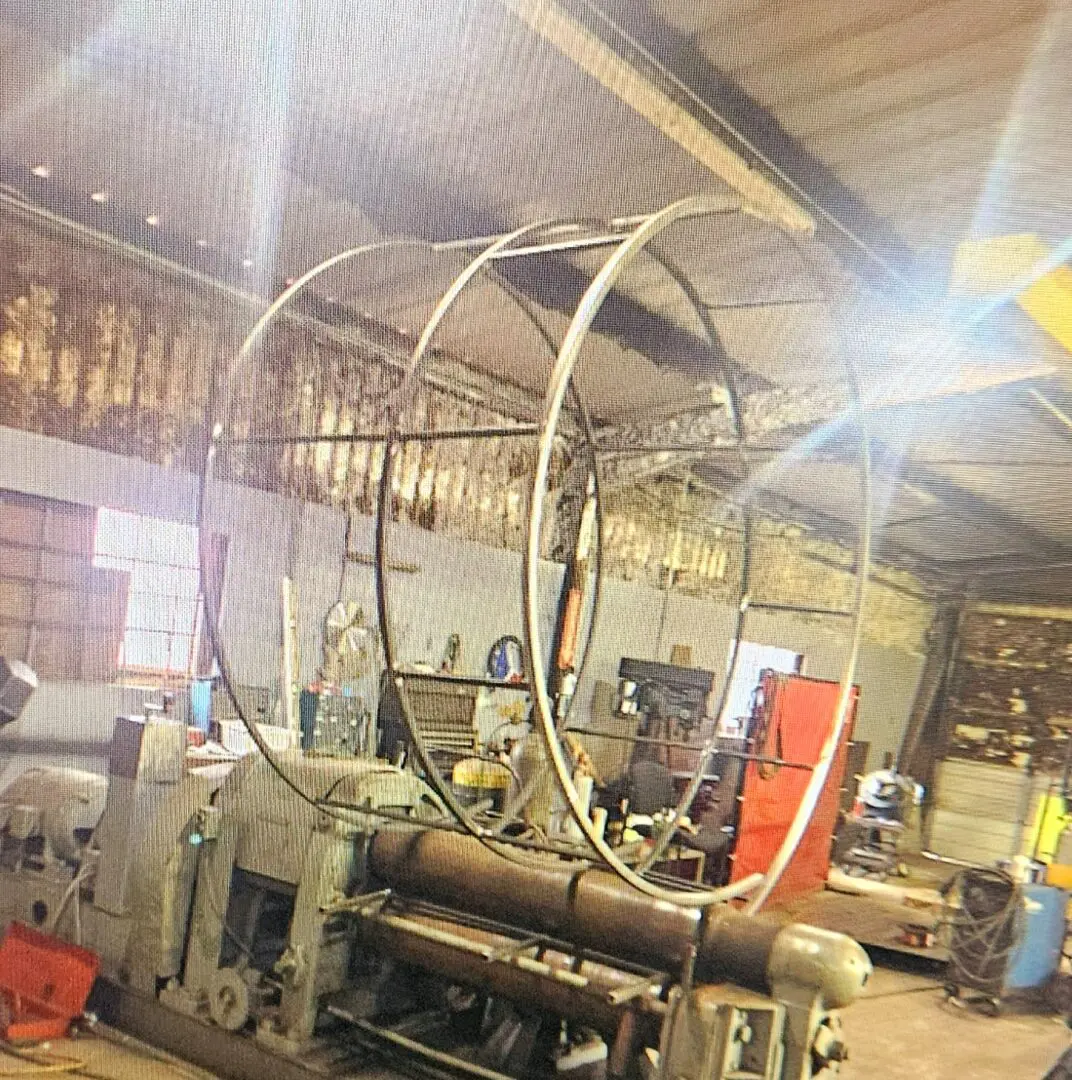 A large machine in a room with lots of machinery.