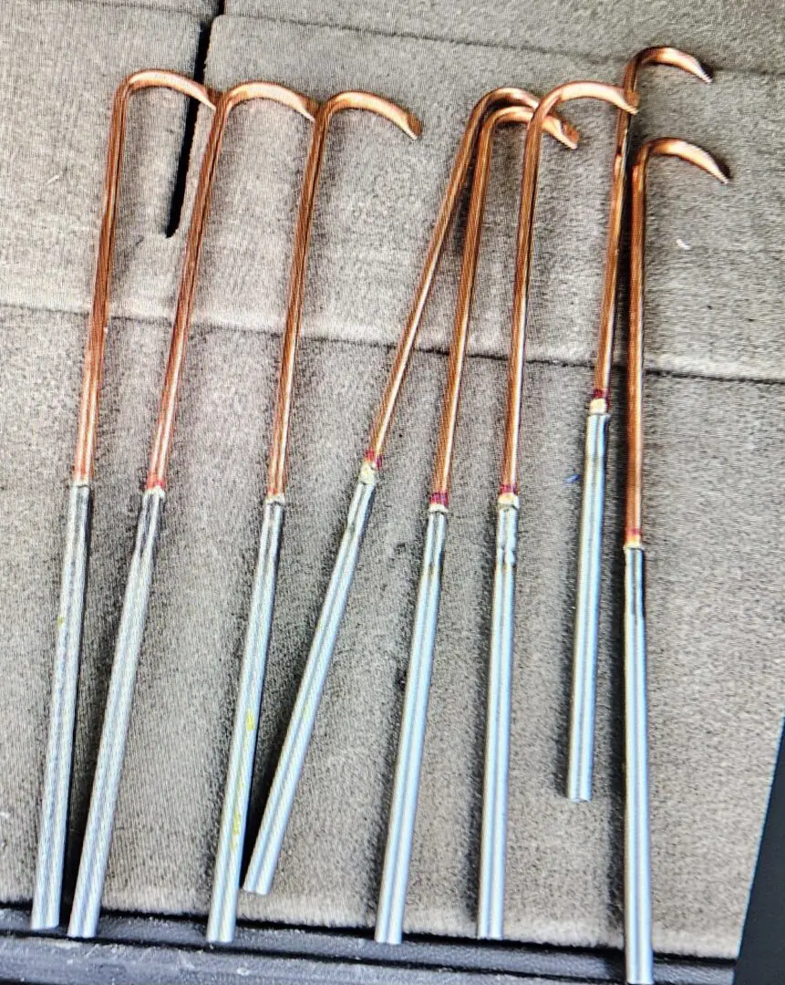 A group of copper and steel walking sticks.