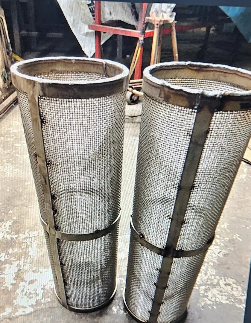 Two metal pipes sitting next to each other.