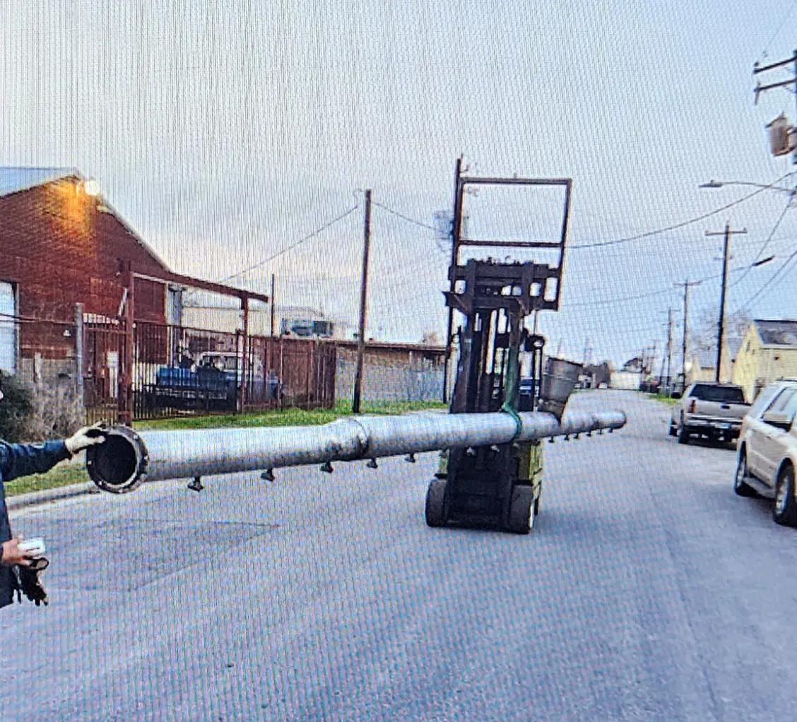 A large pipe laying on top of the road.