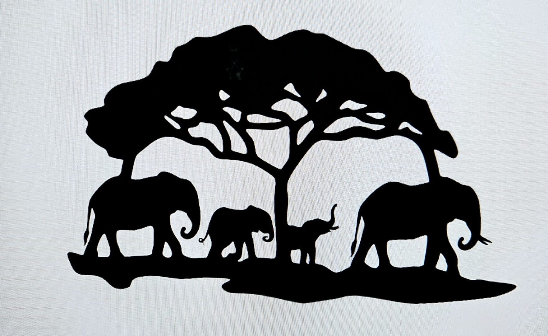 A silhouette of elephants under a tree